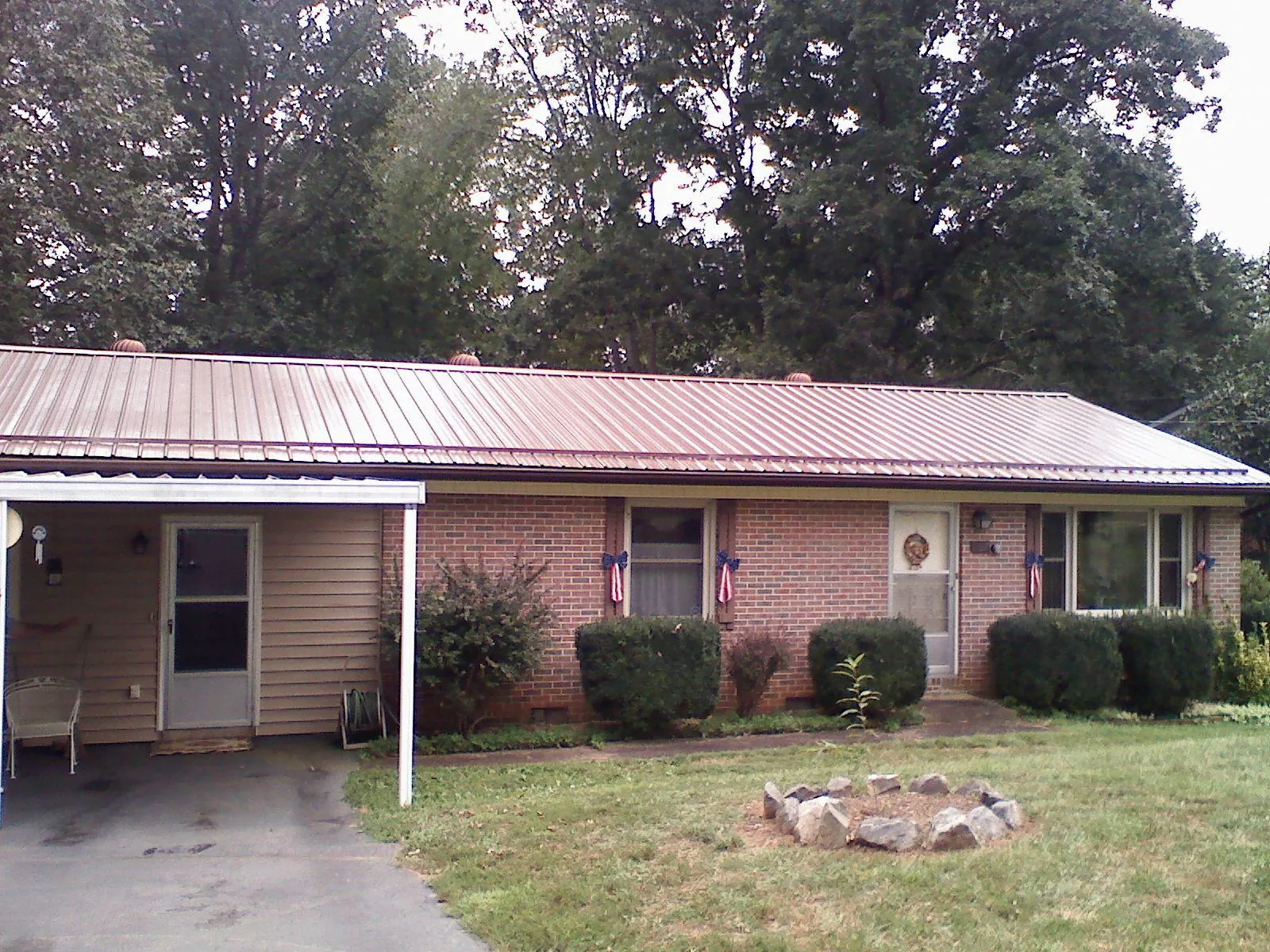 Bronze metal roof and carport on a brick ranch home — Roof Repair work by our crew in Mission Hills